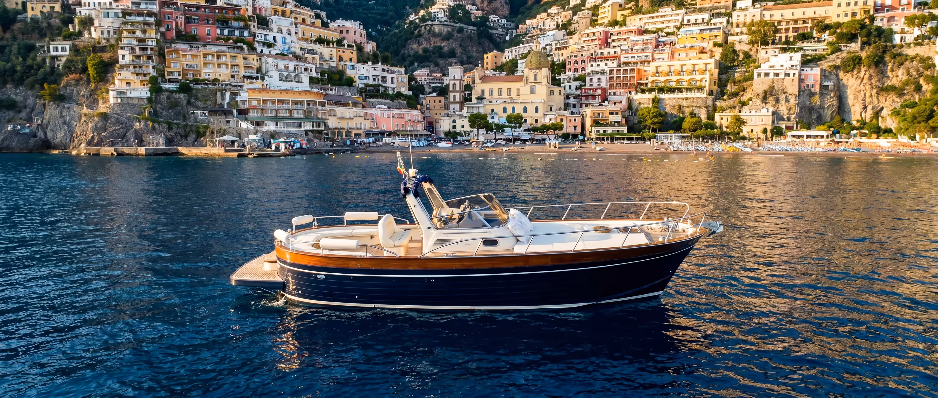 Charter DolceVita private yacht in a secluded cove at sunset
